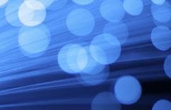 Abstract blue background with light streaks and bokeh circles, symbolizing innovation and digital energy.