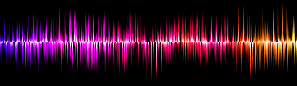 Abstract background of colorful vertical sound waves in blue, purple, pink, and red on a black background symbolising spectrum.